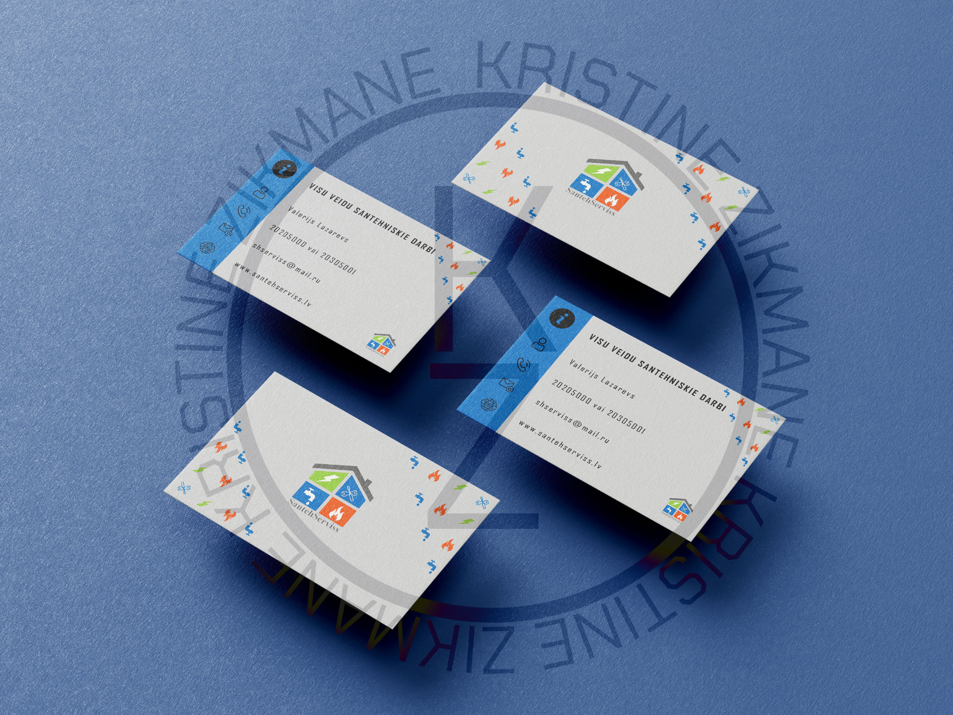 SantehServiss business cards arranged on a blue surface, showing front and back designs