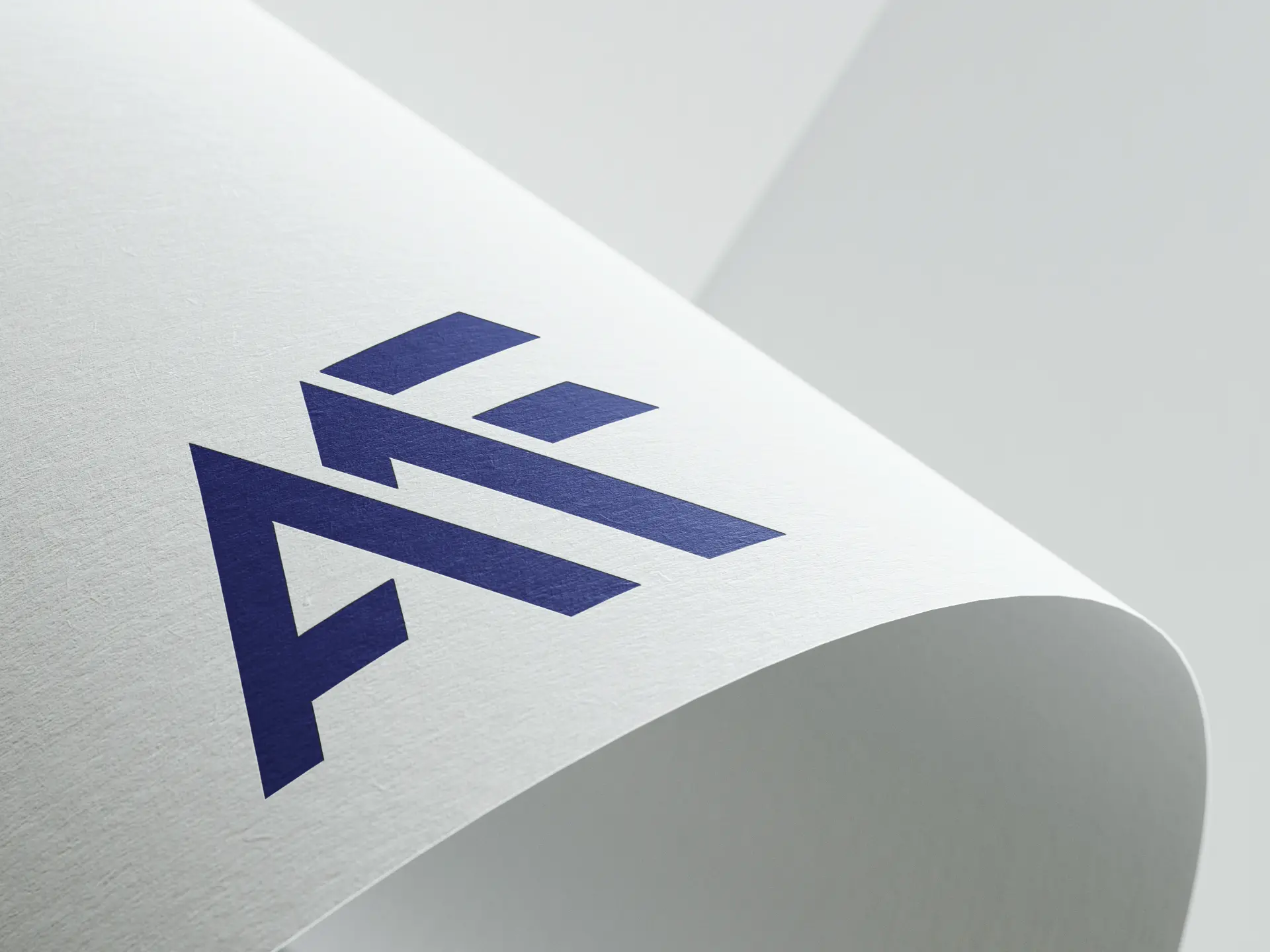 AMF monogram logo in indigo applied to a light paper surface